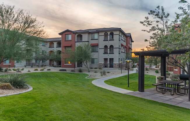 a park with a picnic table in the middle of a grassy area