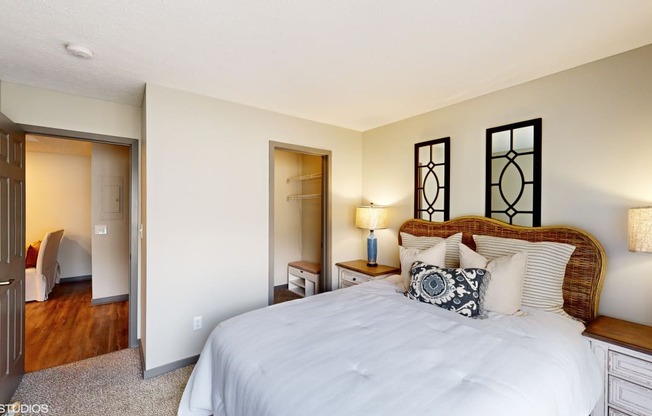 a bedroom with a large bed and a closet