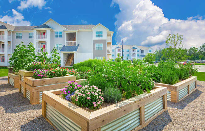 Apartment complex with a garden in front.