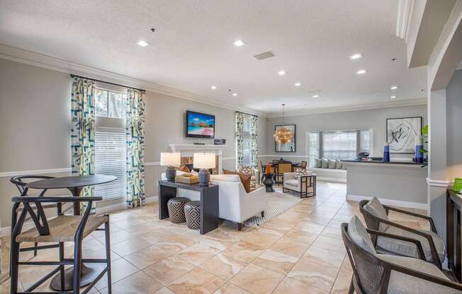 A well-lit living room with a dining table and chairs.