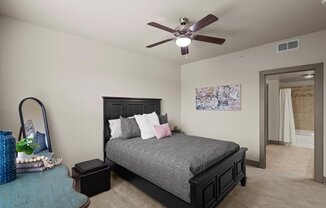 a bedroom with a bed and a ceiling fan