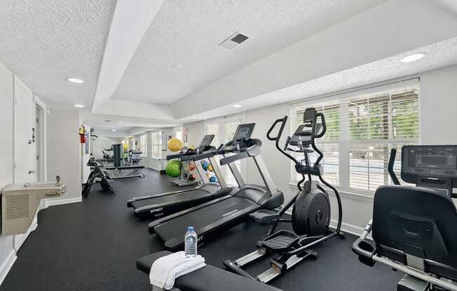 A well-equipped gym with treadmills, exercise bikes, and other fitness equipment.