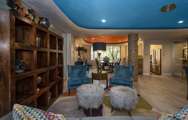 a living room filled with furniture and a blue ceiling