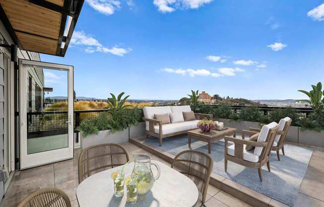 A patio with a table set for four and a view of the mountains.