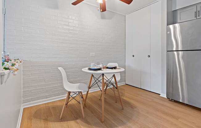 A small dining area with a white table and chairs.