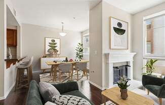 A living room with a fireplace and a dining table.