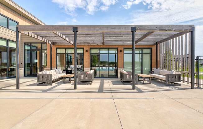 a patio with chairs and awning in front of a building at Statesman Apartments, Franklin