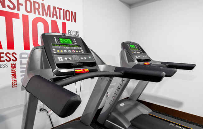 a close up of two treadmills in a gym