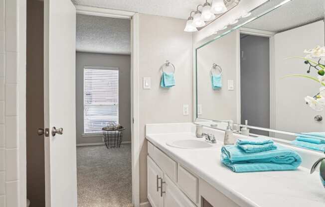 Model A2 floor plan bathroom with a sink and a mirror Noel on The Parkway in Dallas, TX