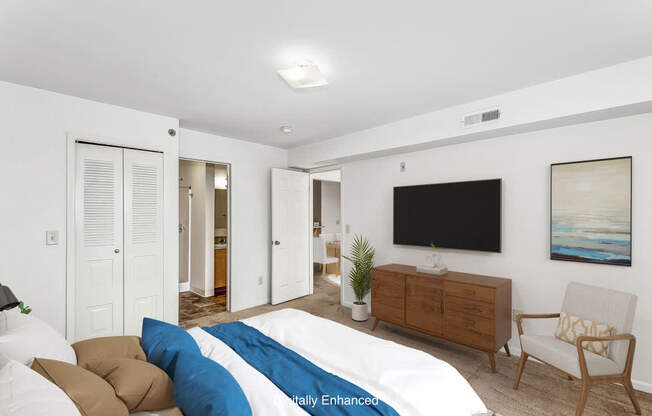 A bedroom with a walk in closet and an attached bathroom at Colonial Pointe at Fairview Apartments, Bellevue, Nebraska