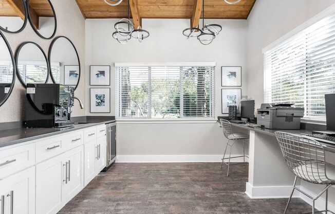 A kitchen with white cabinets and a wooden ceiling.
