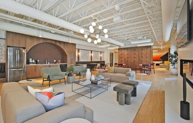 A modern living room with a grey sofa and a glass coffee table.