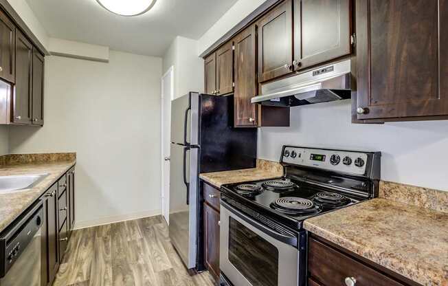 A kitchen with a stove, oven, and cabinets.