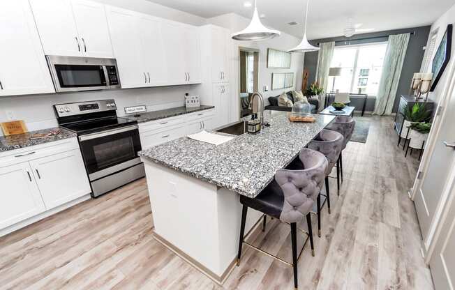 a kitchen with a center island next to a stove top oven