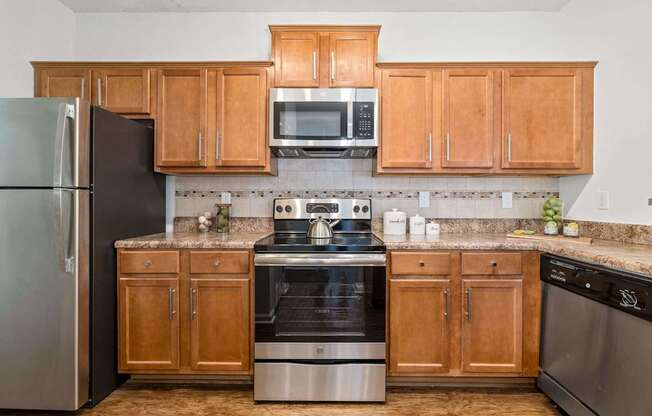 A kitchen with wooden cabinets and stainless steel appliances.