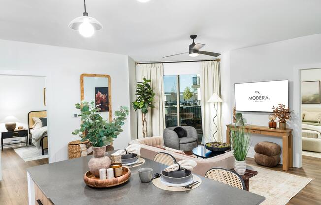 An open-concept living space at Modera Nations in Nashville highlights wide-plank flooring, natural light, and seamless flow designed for everyday living.