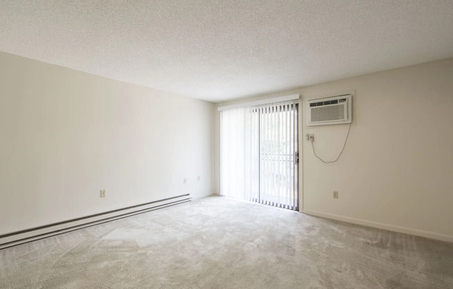 Roomy living area with sliding doors and AC unit  | Princeton Place | Apartments For Rent Near Worcester MA