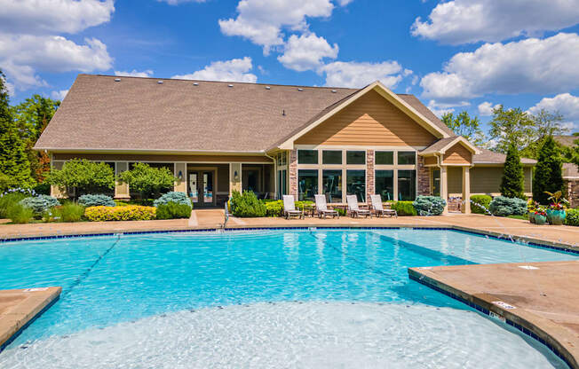 a swimming pool with a house in the background at Sovereign at Overland Park, Overland Park, KS 66213  