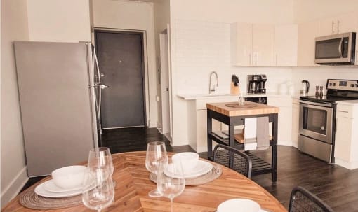 a kitchen and dining room with a wooden table