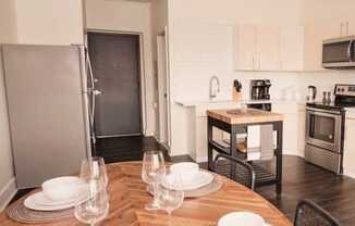 a kitchen and dining room with a wooden table