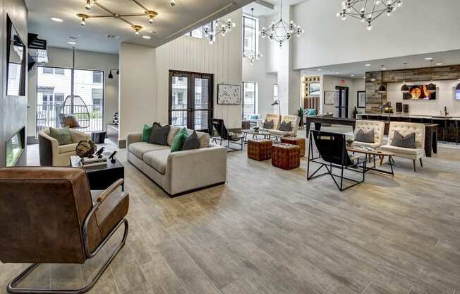 a living room with couches and chairs and a dining room table and a kitchen at Arise Riverside, Austin, 78741