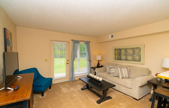 Classic Living Room Design With French Door to Private Patio at West Hampton Park Apartment Homes, Elkhorn
