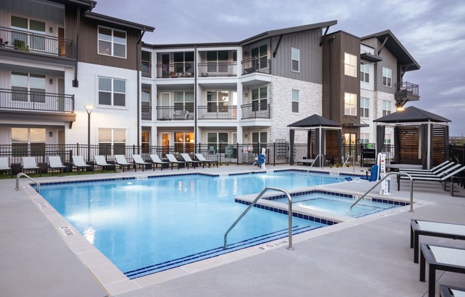 a swimming pool in front of an apartment building