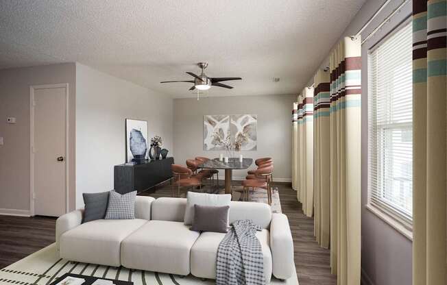 A living room with a white couch and a television.