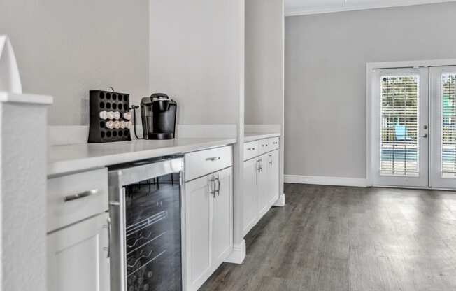 a kitchen with white cabinets and stainless steel appliances and a window