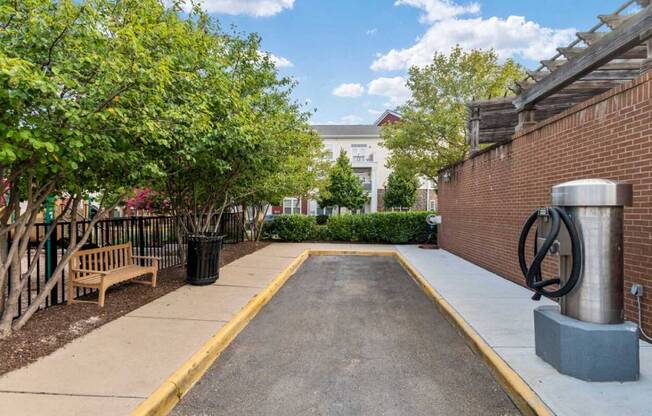 the courtyard of a building with a bench and a fountain