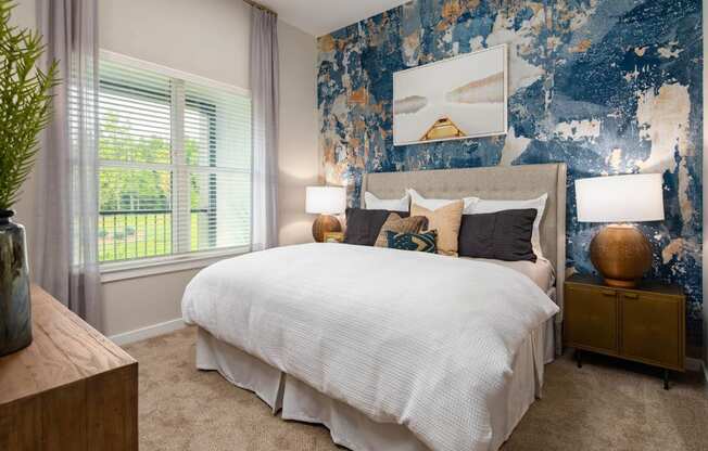 a bedroom with a bed and a blue and white wallpaper