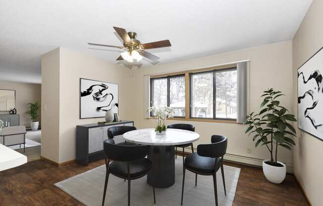 a dining room with a table and chairs and a ceiling fan. Anoka, MN Dellwood Estates