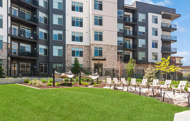 Outdoor Picnic Area with Lounge Furniture and View of Swimming Pool at Seven Skies Apartments located in Sandy, UT.