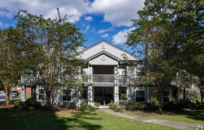 A house with a grey roof and a balcony.