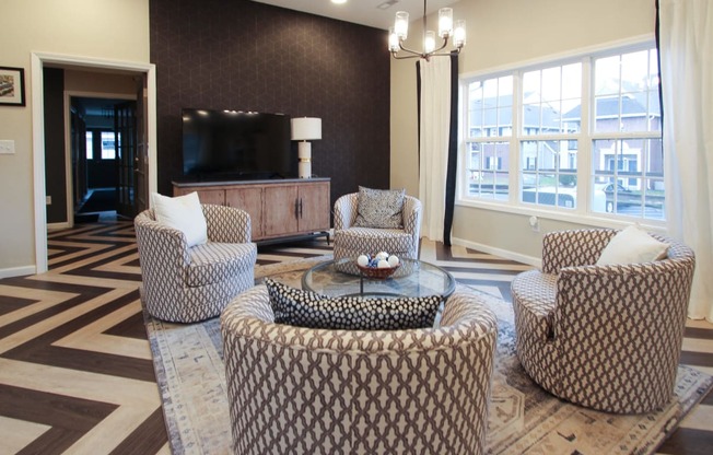 a living room with couches and chairs and a television