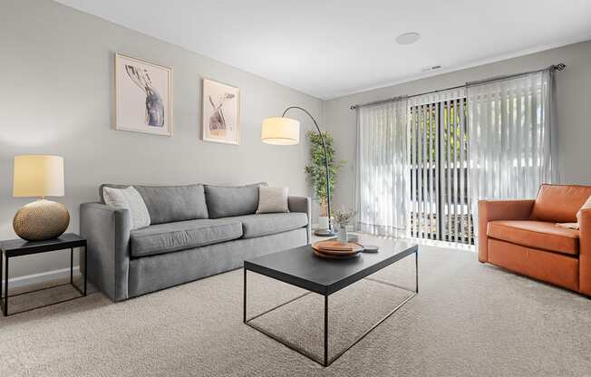 Spacious Living Room with Sliding Glass Door at Lakeside Village Apartments Clinton Township MI