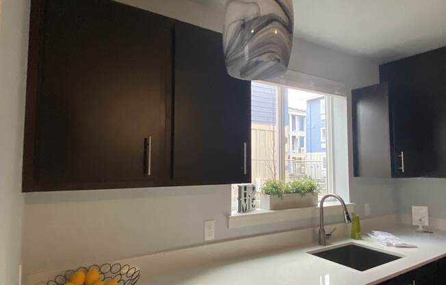 A kitchen with a bowl of lemons on the counter.