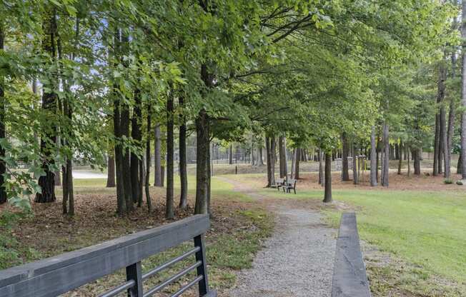 a path through a park with trees and a fence at Trails at Short Pump Apartments, Virginia, 23233