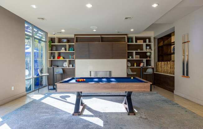 Resident clubhouse with pool table and book shelf