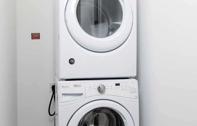 A white washing machine and dryer in a small room.