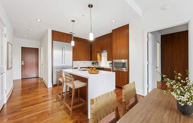 A kitchen with wooden floors and furniture.