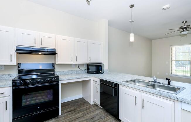 Apartments for Rent in Leander TX - Hills at Leander Spacious Kitchen with Plenty of Counterspace, Fully Equipped with Black Appliances, and Much More