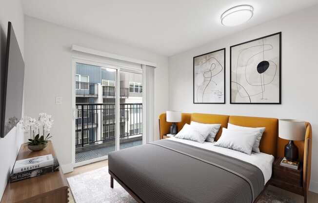 a bedroom with a large window and a bed with a yellow headboard