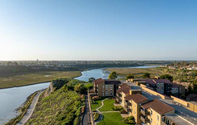 an aerial view of a city with a river and buildings