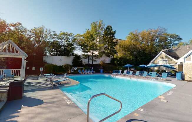 a swimming pool with chairs and a resort style pool
