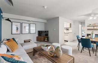 a living room and dining room with a couch and a table