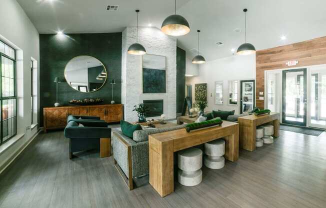 A modern living room with a dark green sofa and a wooden coffee table.