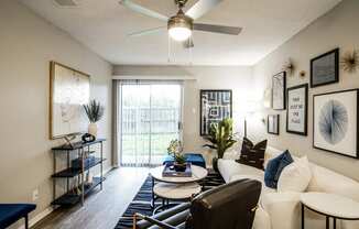 our apartments offer a living room with a ceiling fan and a balcony