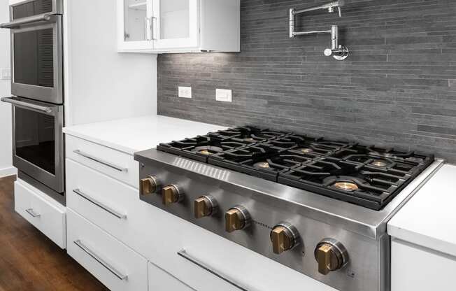 a kitchen with a stove top oven and a sink