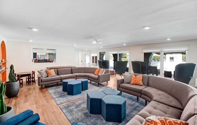 a living room with couches and chairs and a dining room with a table